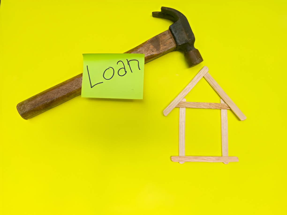 house art made with popsicle sticks and a hammer with a 'loan' sticky note