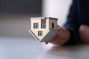 miniature house held upside down